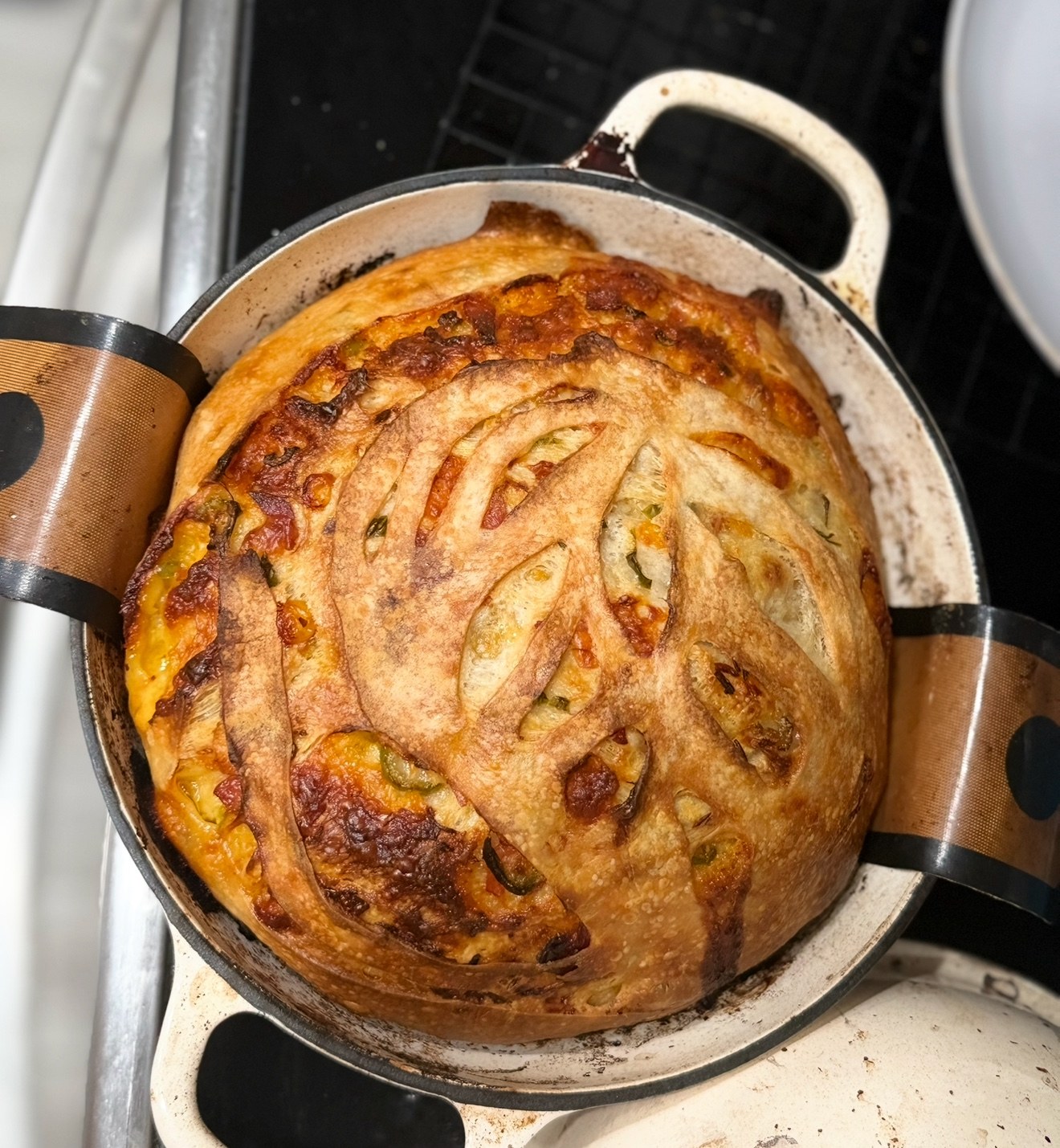 A golden savory boule fresh from the Dutch oven